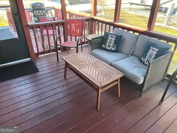 a balcony with wooden floor outdoor seating and stairs