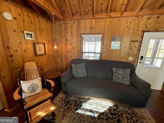 a living room with furniture a rug and a window