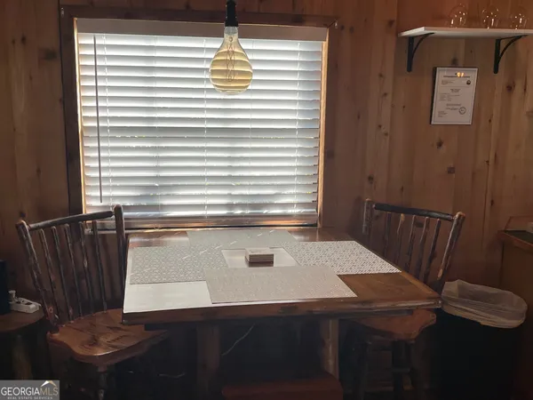 a view of a dining room with furniture and window