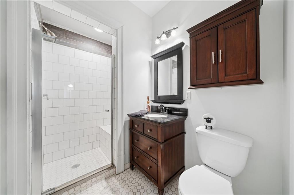 1523 Evergreen Road Pittsburgh, PA 15209 - Photo 16 of 35 a bathroom with a toilet a sink and glass door
