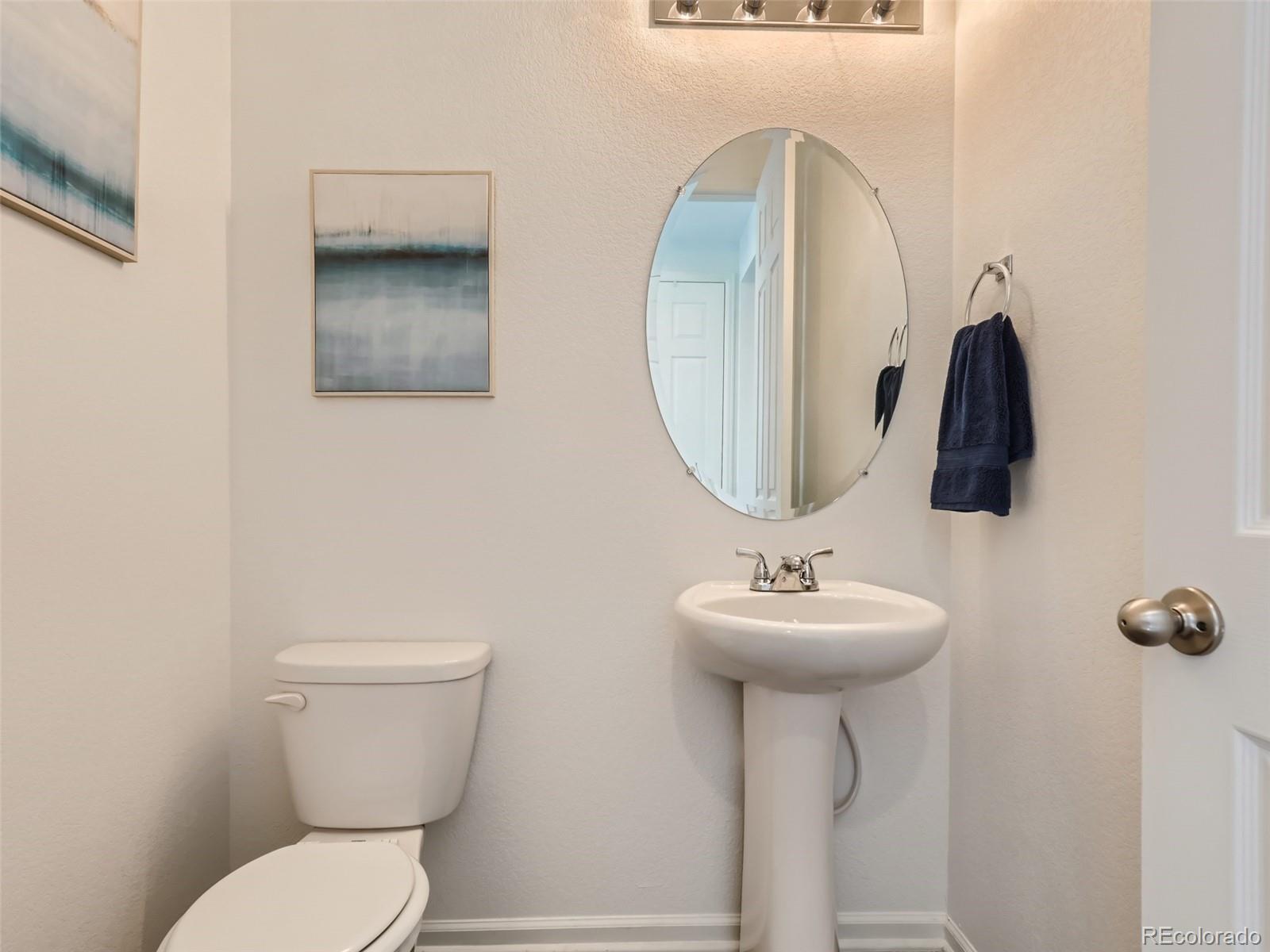 6430 Dry Fork Circle Frederick, CO 80516 - Photo 11 of 32 a bathroom with a sink toilet and a mirror