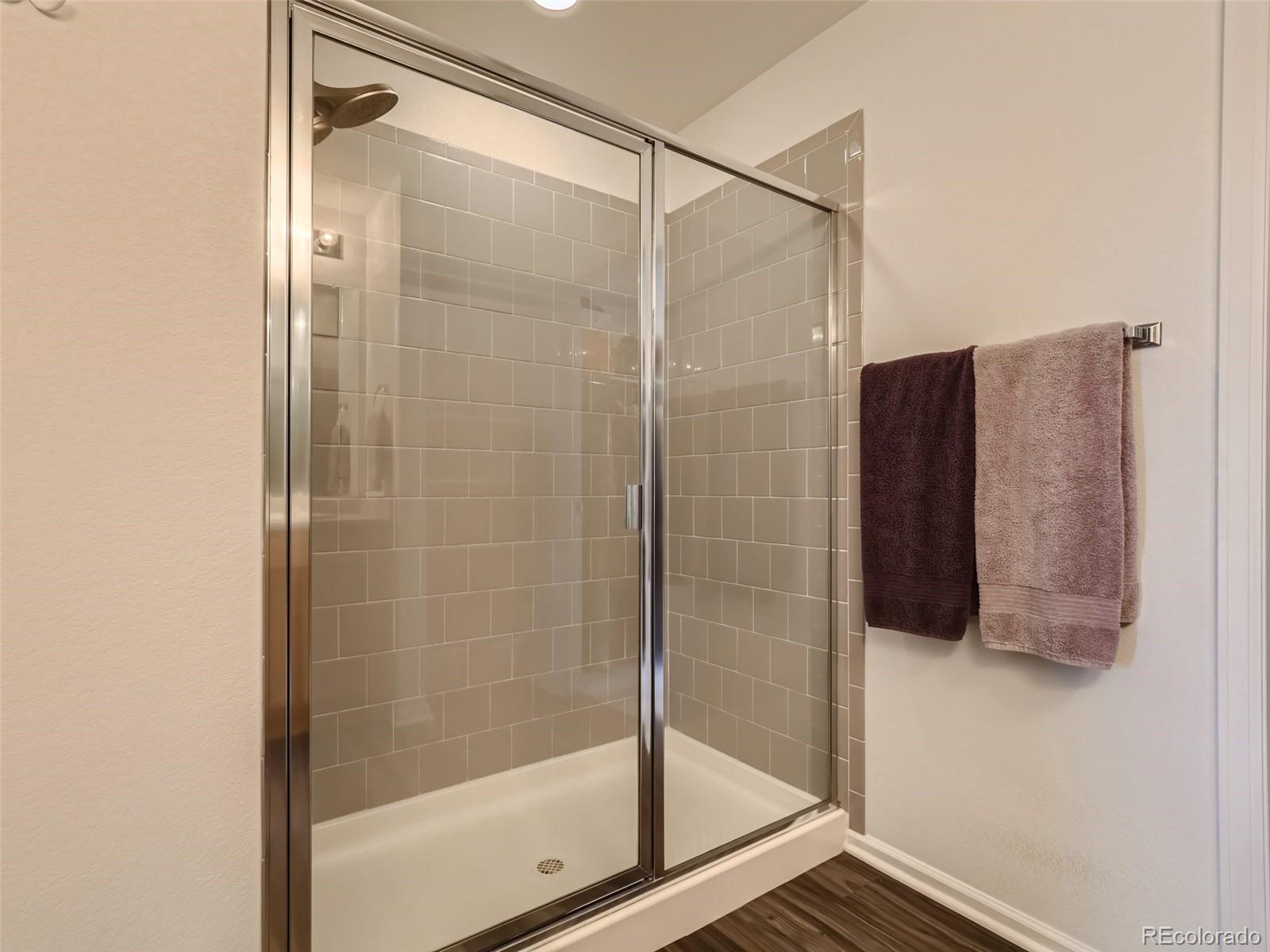 6430 Dry Fork Circle Frederick, CO 80516 - Photo 16 of 32 a bathroom with a shower and a mirror