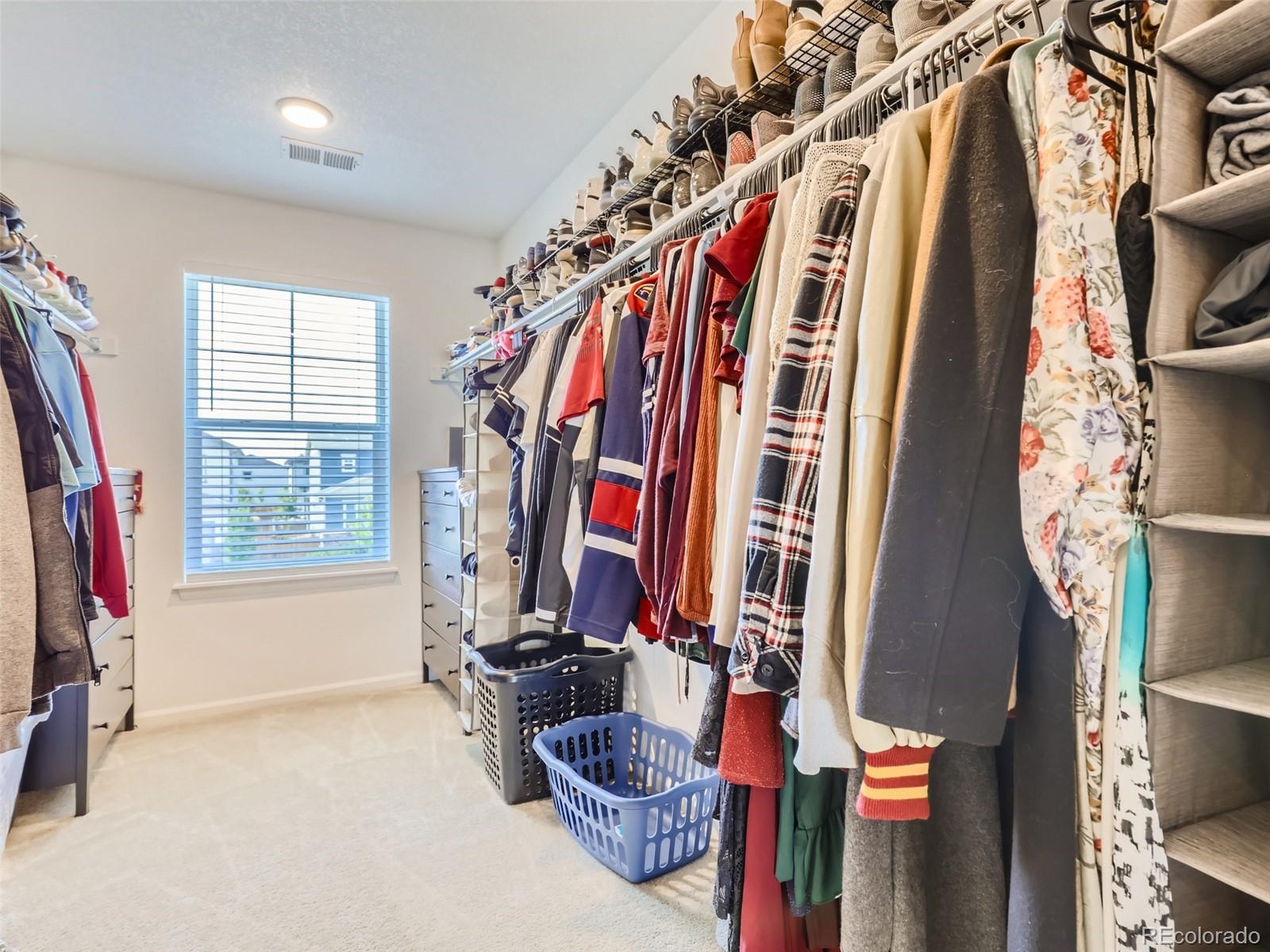 6430 Dry Fork Circle Frederick, CO 80516 - Photo 17 of 32 a view of walk in closet with clothes and shoes