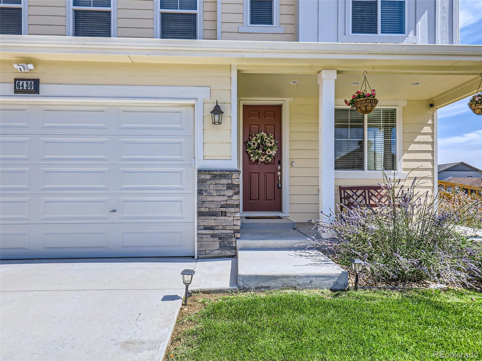 6430 Dry Fork Circle Frederick, CO 80516 - Photo 2 of 32 a front view of a house with a garden