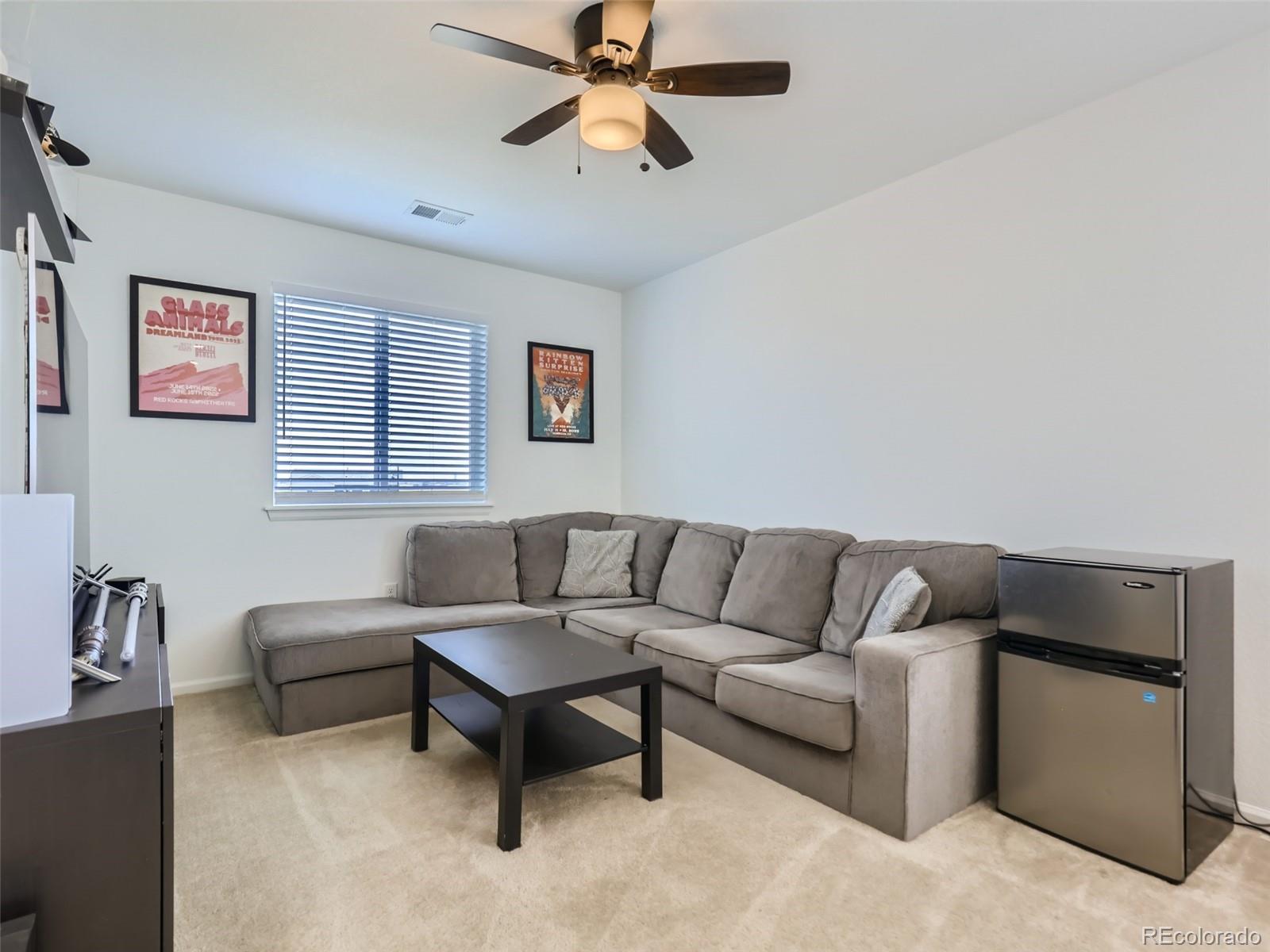 6430 Dry Fork Circle Frederick, CO 80516 - Photo 22 of 32 a living room with furniture and a ceiling fan