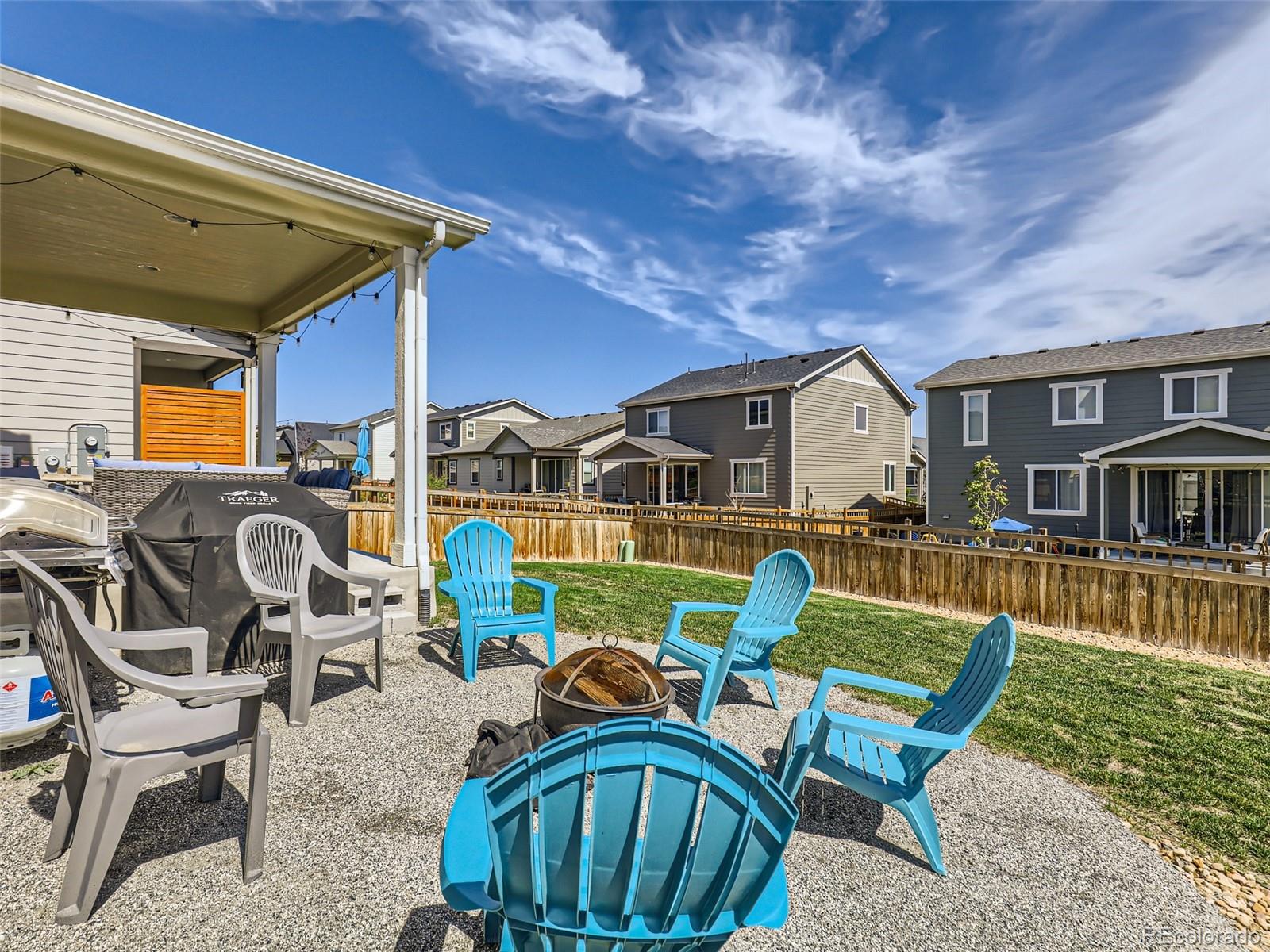 6430 Dry Fork Circle Frederick, CO 80516 - Photo 25 of 32 a view of a patio with table and chairs with wooden floor and fence