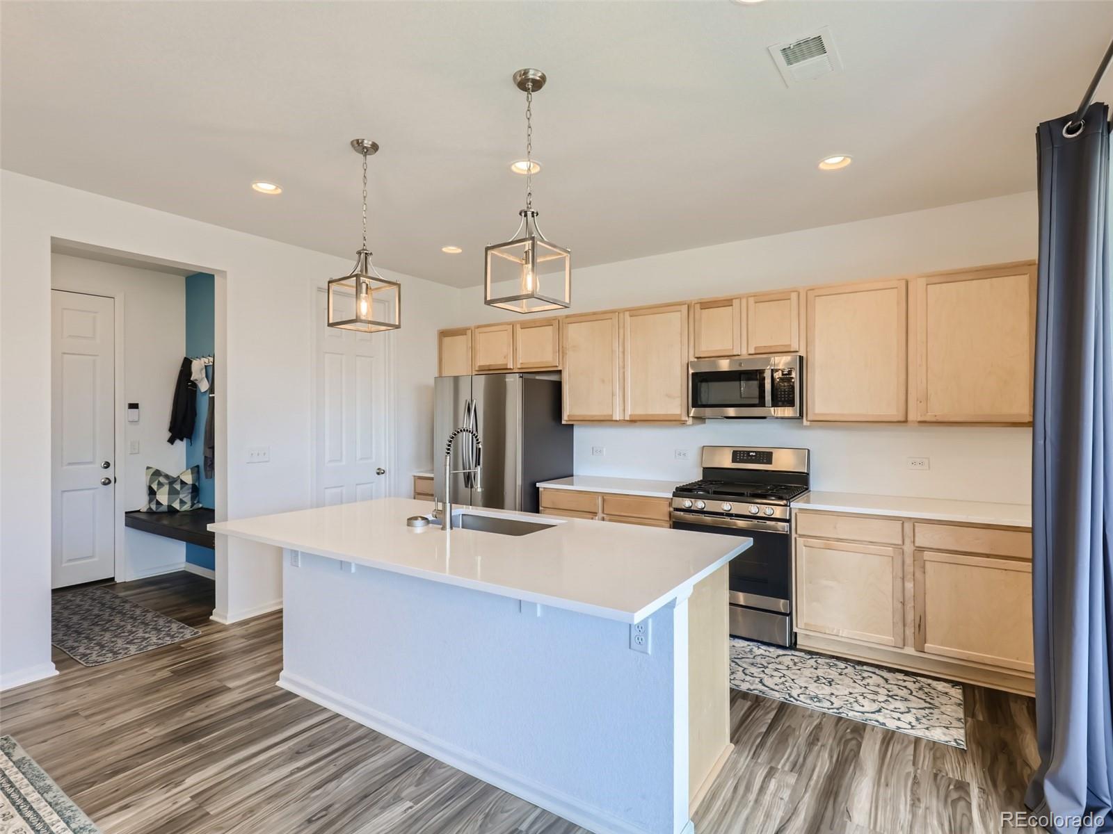 6430 Dry Fork Circle Frederick, CO 80516 - Photo 6 of 32 a kitchen with stainless steel appliances a stove sink and refrigerator