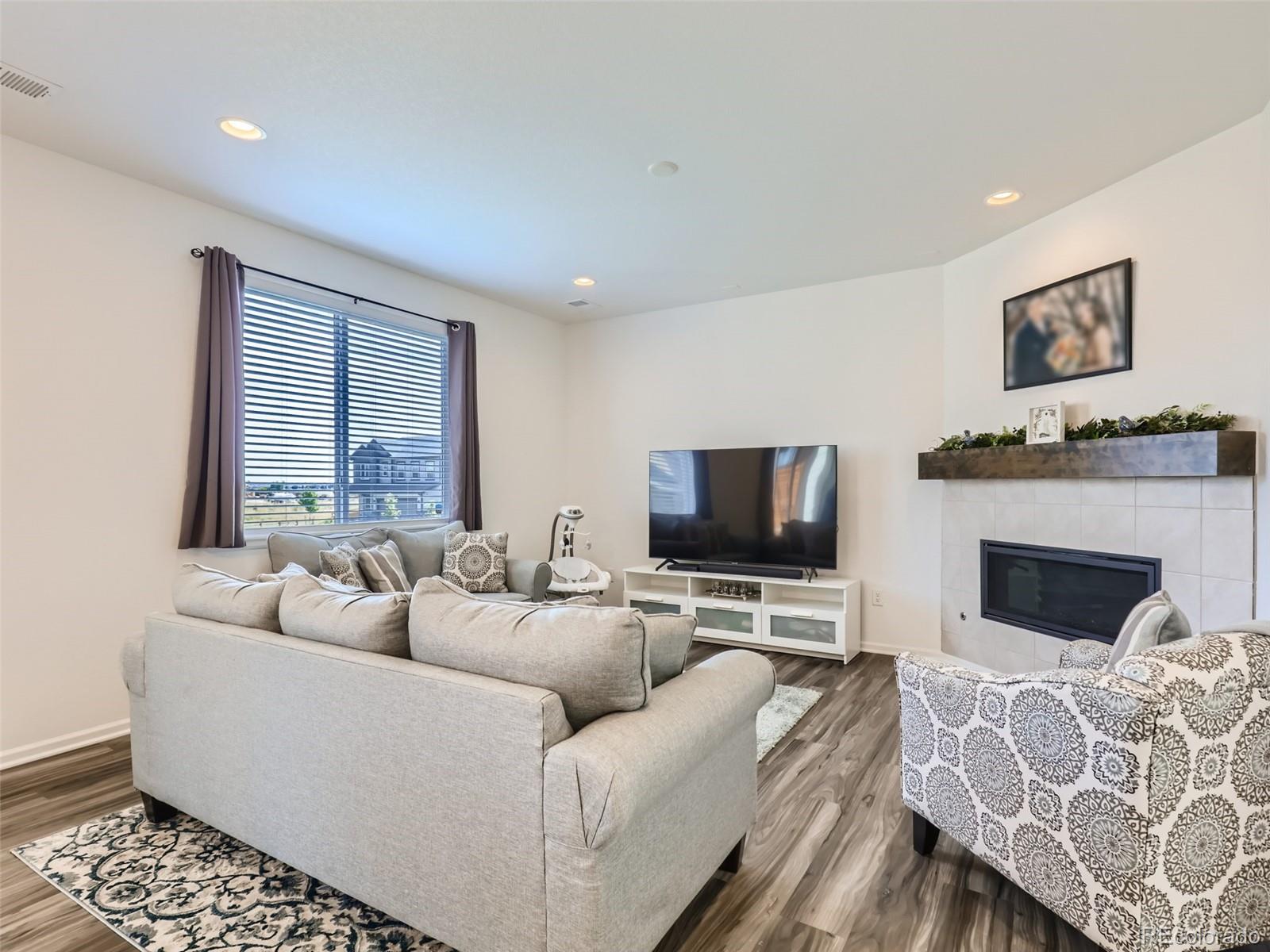 6430 Dry Fork Circle Frederick, CO 80516 - Photo 8 of 32 a living room with furniture and a flat screen tv