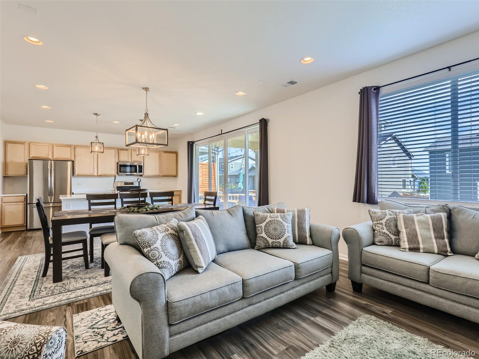 6430 Dry Fork Circle Frederick, CO 80516 - Photo 9 of 32 a living room with furniture kitchen area and a window
