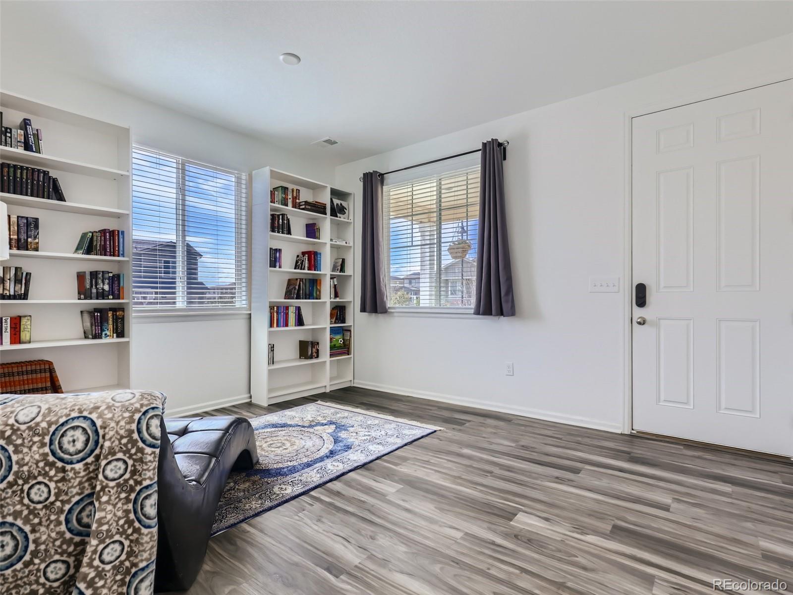 6430 Dry Fork Circle Frederick, CO 80516 - Photo 10 of 32 a bedroom with furniture and a book shelf