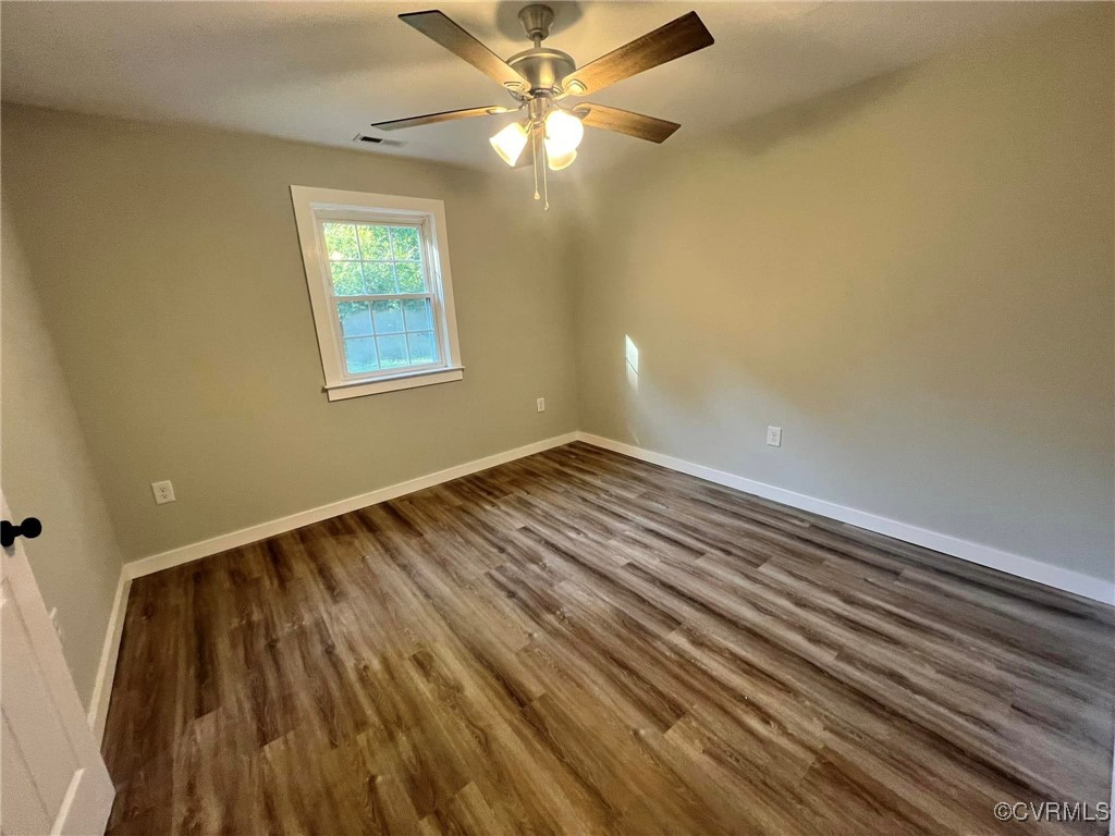 9427 Lebanon Church Road Jarratt, VA 23867 - Photo 10 of 16 Unfurnished room with hardwood / wood-style floors