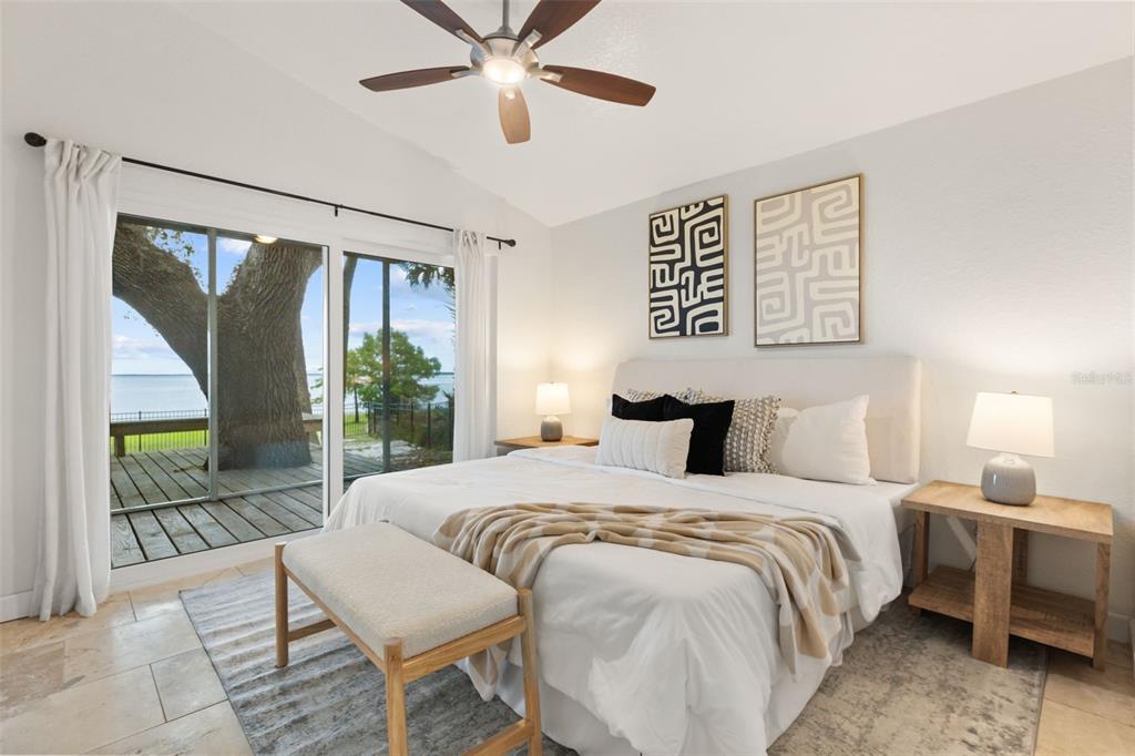 2462 Fort Lane Road Geneva, FL 32732 - Photo 12 of 31 a bedroom with a large bed and a chandelier