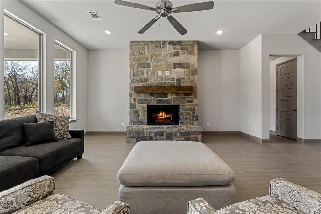 131 Spring Valley Road Paradise, TX 76073 - Photo 8 of 40 a bed room with furniture and a fireplace
