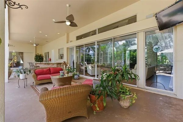 a living room with furniture a fireplace and a chandelier