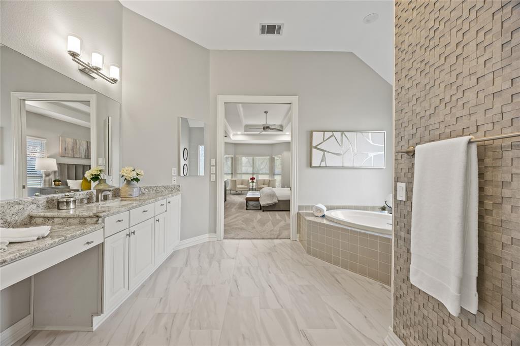 10409 Countryside Drive Denton, TX 76207 - Photo 27 of 38 Ensuite bathroom featuring vanity, a bath, vaulted ceiling, and a ceiling fan