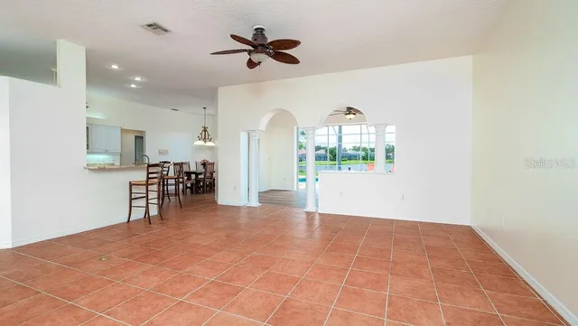 a view of a dining room with furniture and a chandelier