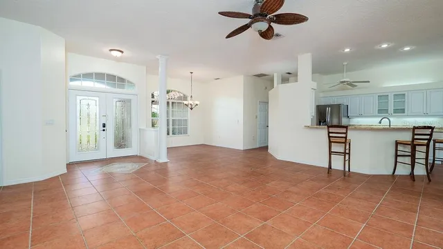 a bedroom with a bed and a view of living room