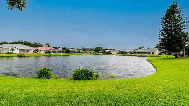 an aerial view of residential houses with outdoor space and swimming pool