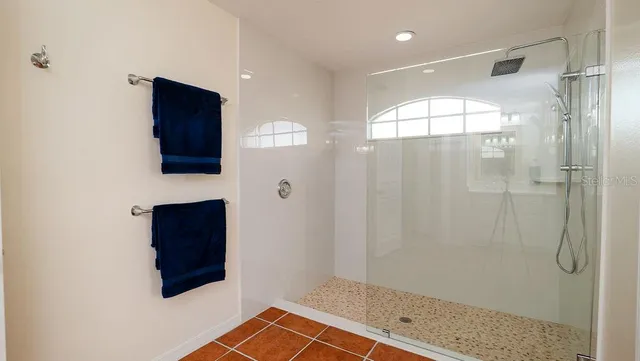 a view of a swimming pool with chairs in patio