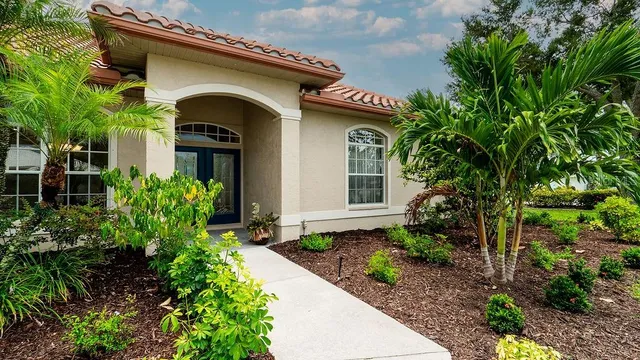 a view of a room that has a chandelier and wooden floor