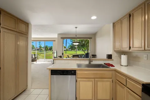 a spacious bedroom with a bed and a flat screen tv