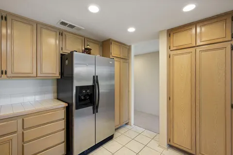 a spacious bathroom with a double vanity sink a mirror and shower