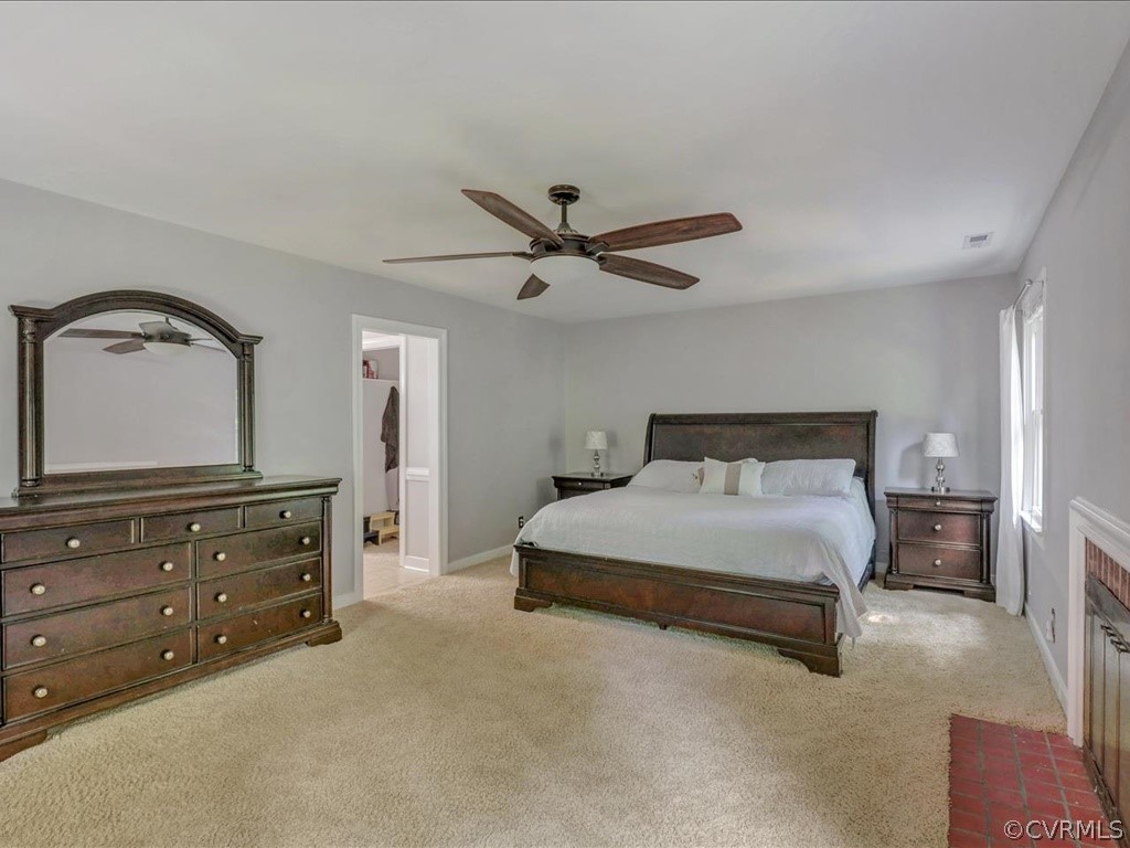 1909 Fairoaks Road Powhatan, VA 23139 - Photo 18 of 34 Master Bedroom with carpet, wood burning brick fir
