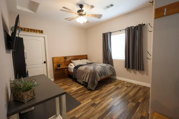 a bedroom with a bed and a chandelier