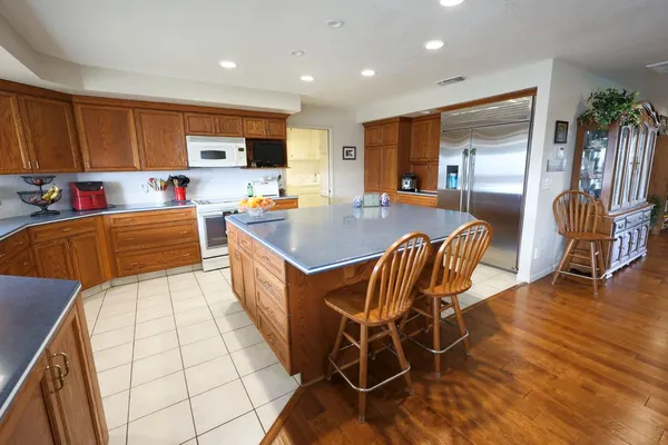 a large kitchen with a table and chairs in it