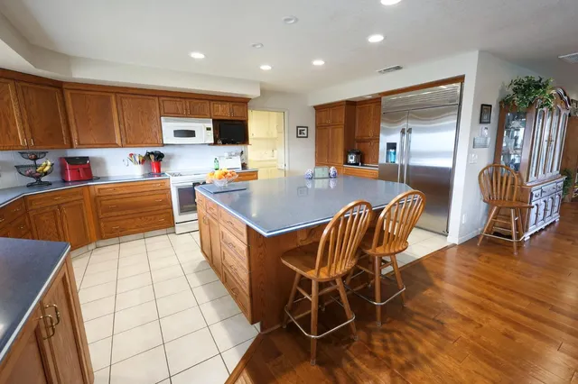 a large kitchen with a table and chairs in it