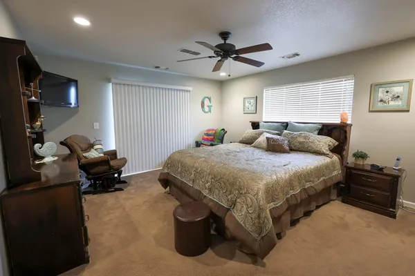 a bedroom with a bed and a chandelier