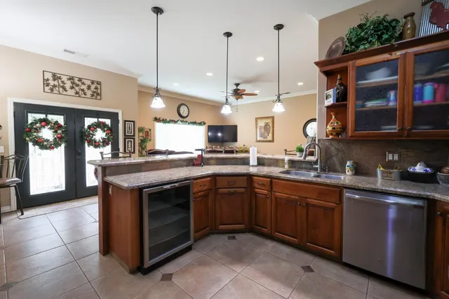 a kitchen with stainless steel appliances granite countertop a stove a sink and a microwave