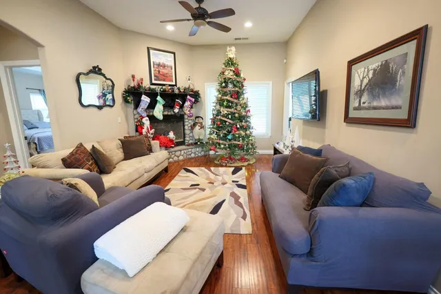 a living room with furniture and a chandelier