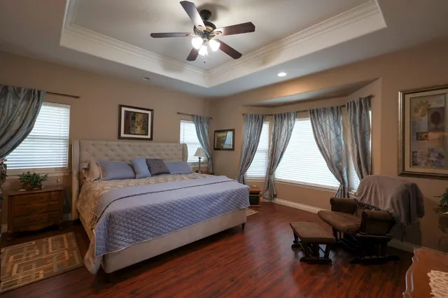 a bedroom with a bed window and a desk