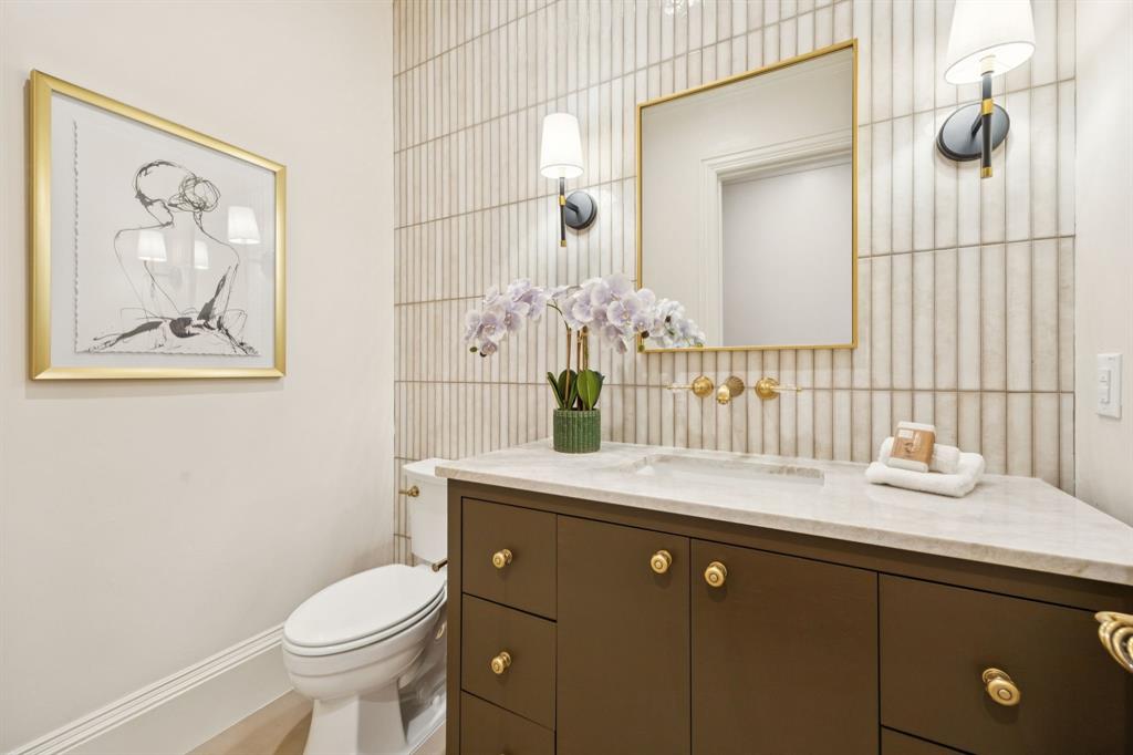 1900 Shady Oaks Drive Southlake, TX 76092 - Photo 17 of 40 a bathroom with a sink vanity granite toilet and a mirror