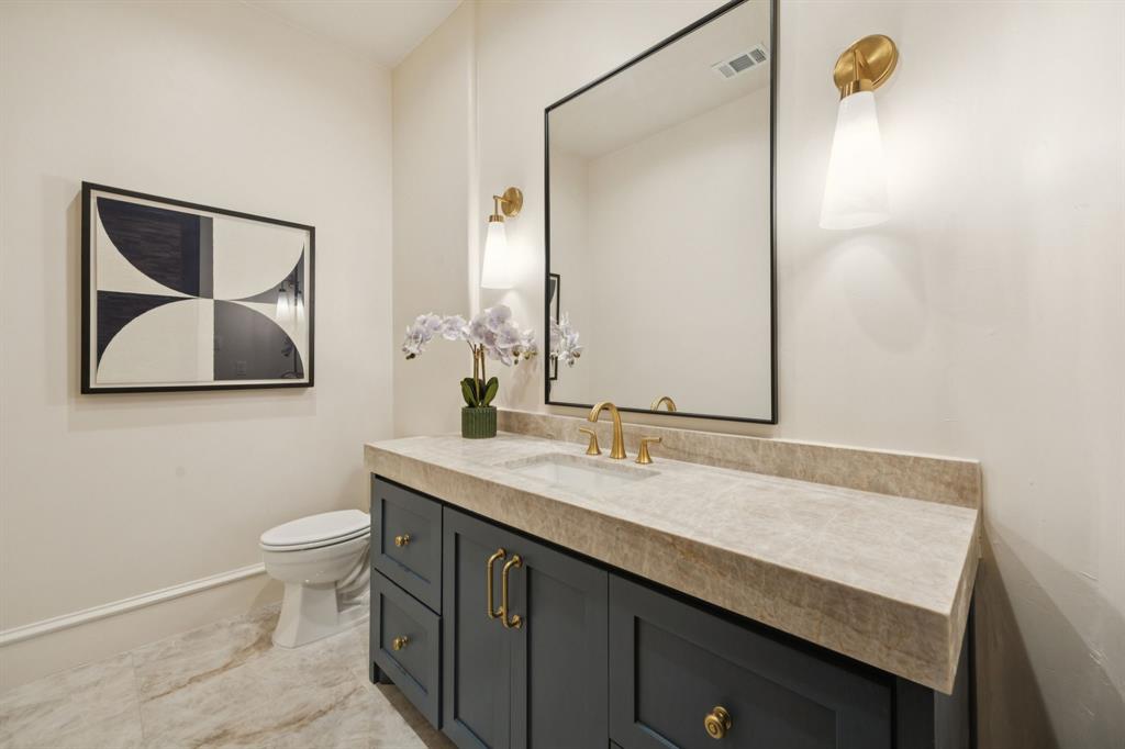 1900 Shady Oaks Drive Southlake, TX 76092 - Photo 20 of 40 a bathroom with a granite countertop sink a toilet and mirror