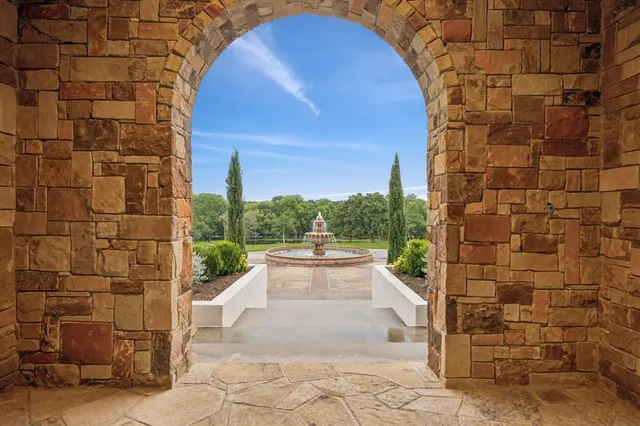 a view of a dining room with furniture large windows and chandelier