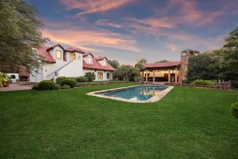 a living room with furniture a chandelier and a rug