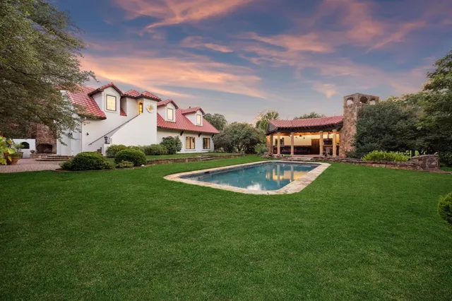 a living room with furniture a chandelier and a rug