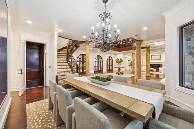 a living room with furniture kitchen view and large windows