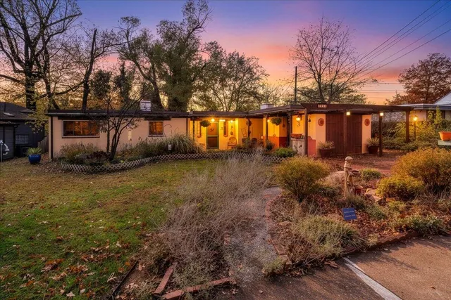 a backyard of a house with lots of green space and fountain