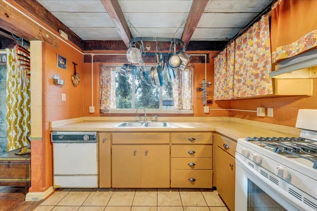 a kitchen with a stove a sink and a refrigerator