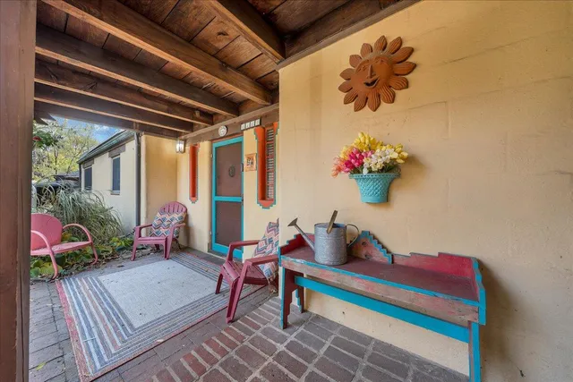 a living room filled with furniture and a potted plant