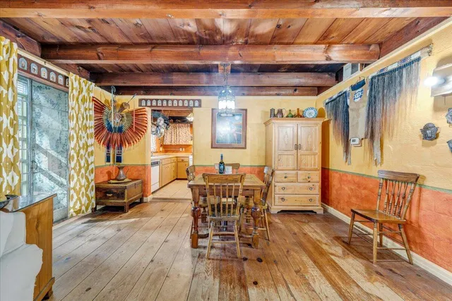a dining room with furniture window and wooden floor