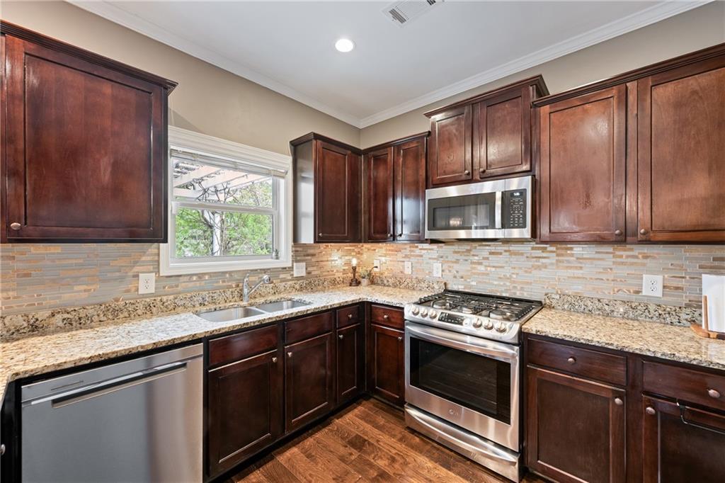 555 Evergreen Way Jefferson, GA 30549 - Photo 24 of 69 a kitchen with a sink stove top oven and cabinets
