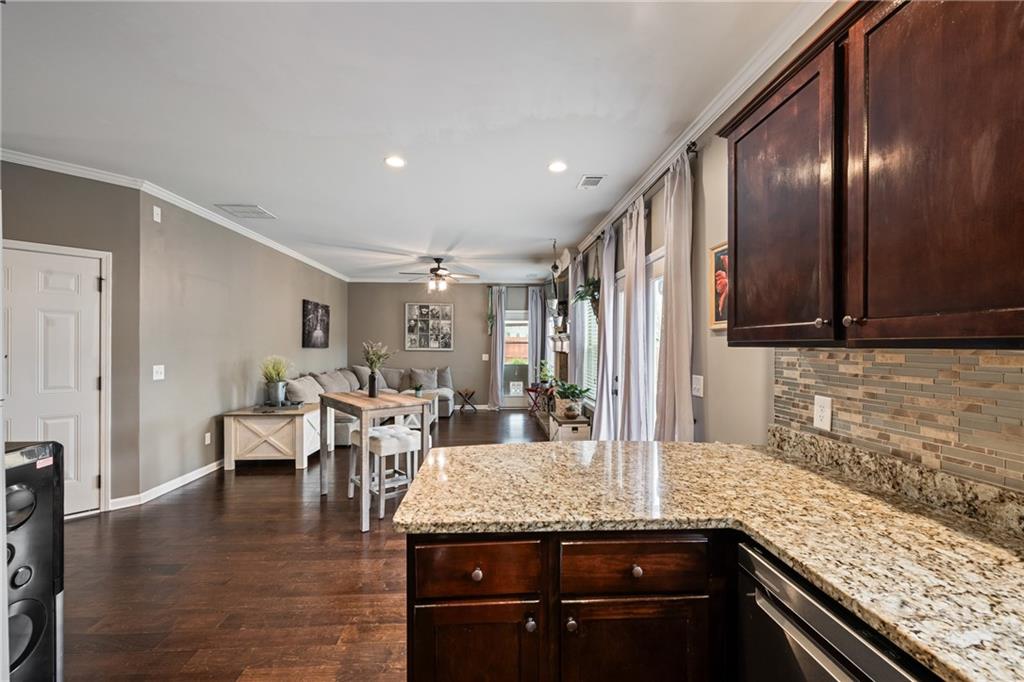 555 Evergreen Way Jefferson, GA 30549 - Photo 27 of 69 a kitchen with granite countertop stainless steel appliances and wooden cabinets