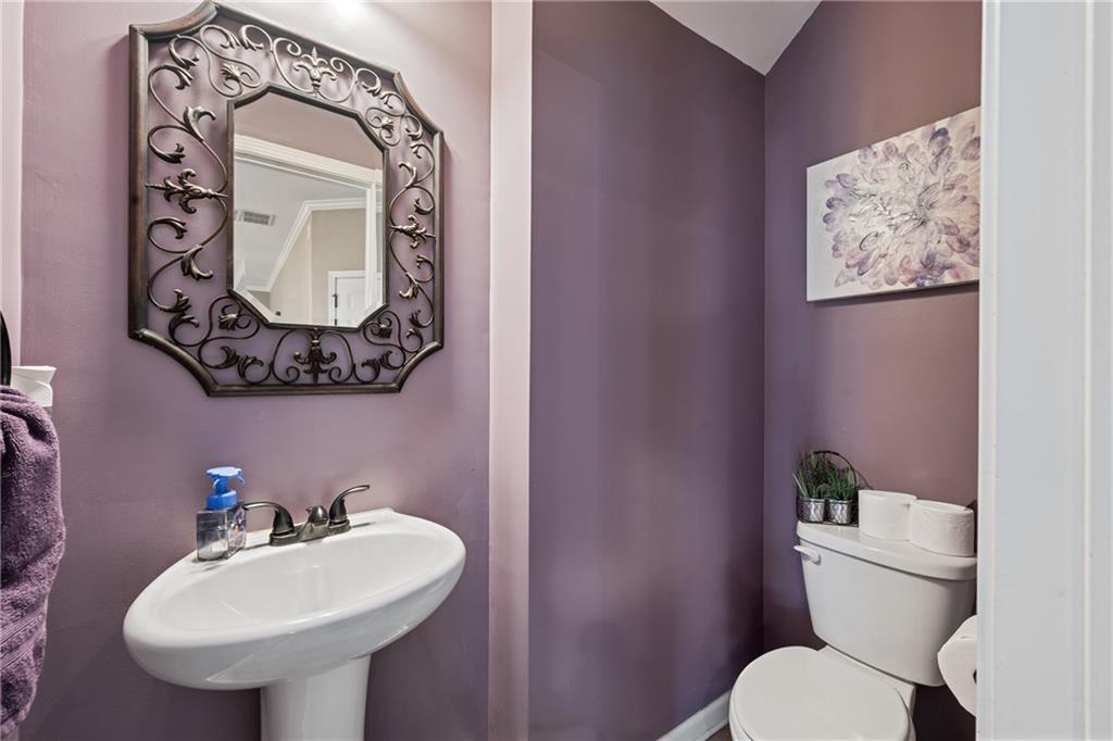 555 Evergreen Way Jefferson, GA 30549 - Photo 31 of 69 a bathroom with a toilet sink and mirror