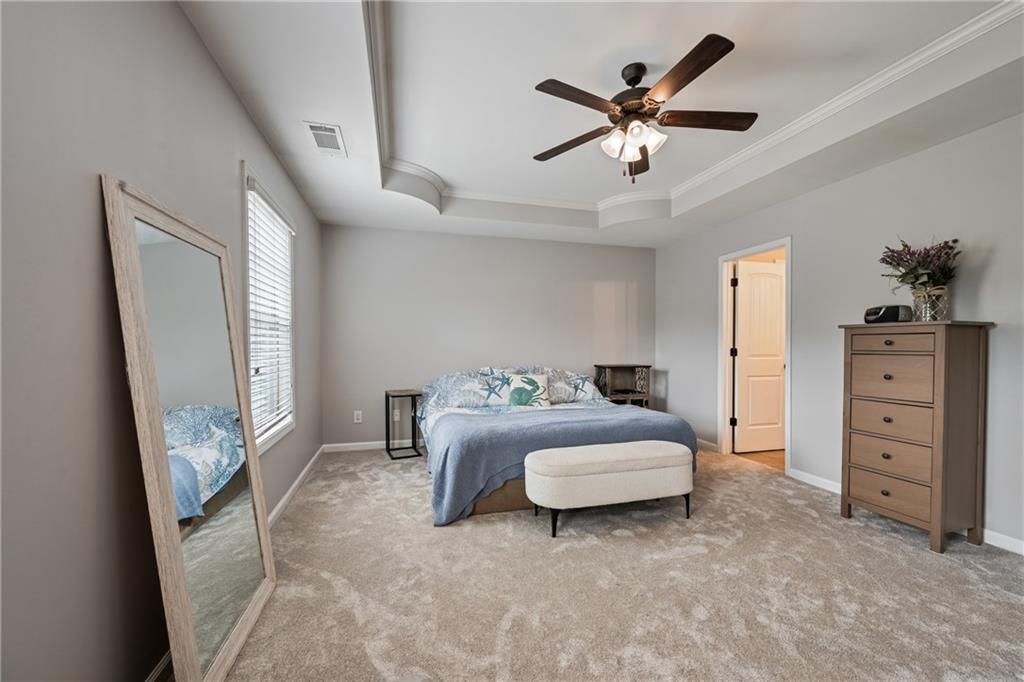 555 Evergreen Way Jefferson, GA 30549 - Photo 34 of 69 a bedroom with a bed and a chandelier