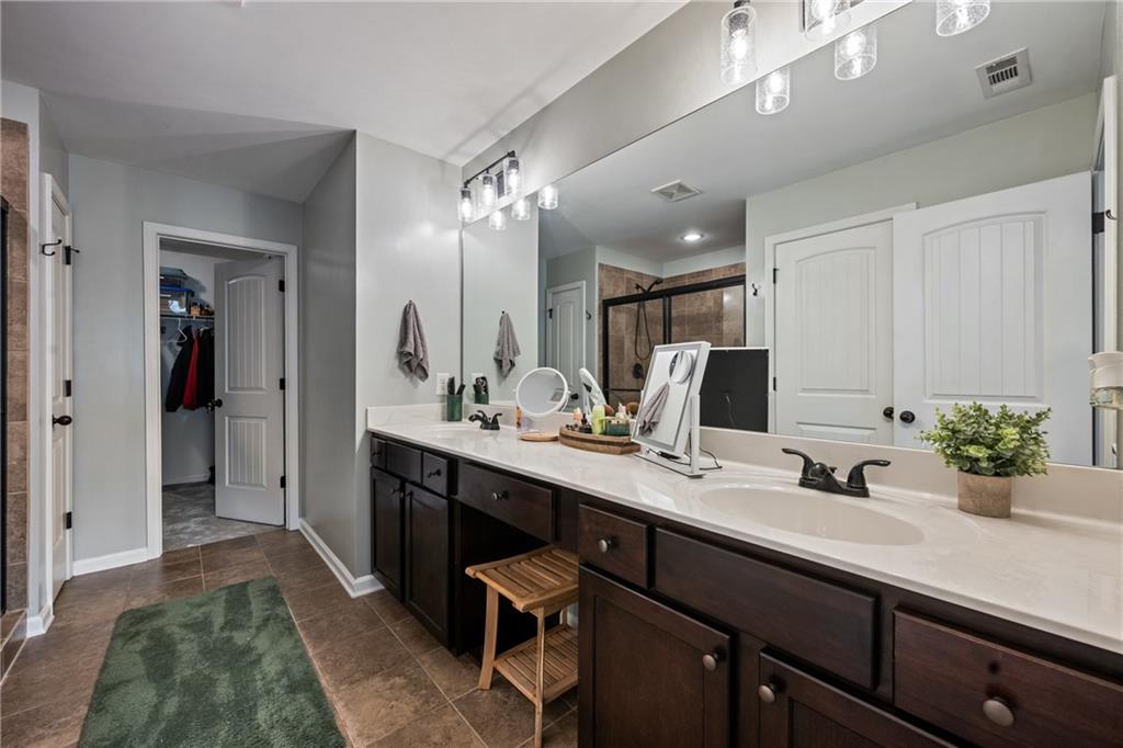555 Evergreen Way Jefferson, GA 30549 - Photo 36 of 69 a bathroom with a sink double vanity and a mirror