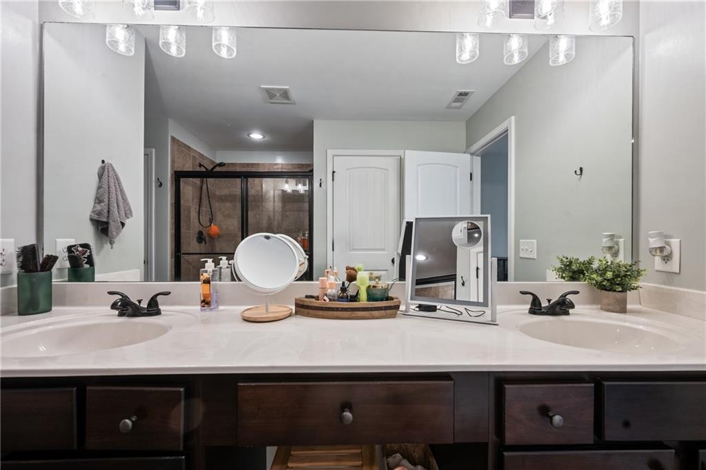 555 Evergreen Way Jefferson, GA 30549 - Photo 37 of 69 a bathroom with a sink and a mirror